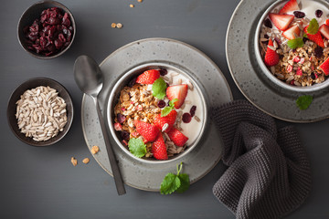 granola and yogurt with seeds and strawberry for breakfast