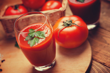 Glasses of fresh tomato juice and tomatoes 