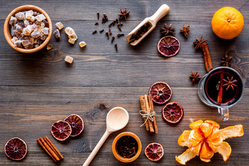 Merry christmas in winter evening with warm drink. Hot mulled wine or grog with fruits and spices on wooden background top view