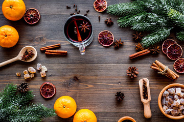 Hot mulled wine or grog cooking for new year celebration with oranges and spices ingredients on...