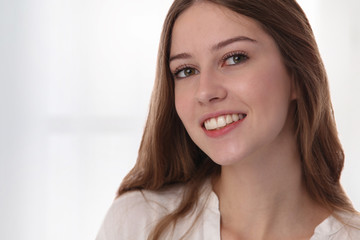 Natural beauty. Close up portrait of happy Girl with Perfect Smile, White Teeth and Clean healthy Skin