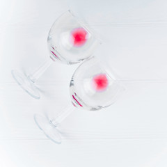 two glasses of wine on white wooden background lie, copy space