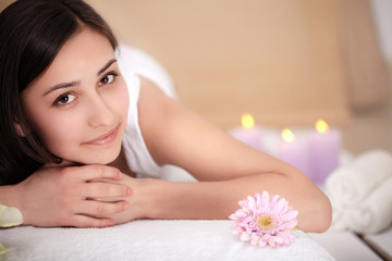 Fototapeta na wymiar Cute young woman enjoying during a skin care treatment at a spa.