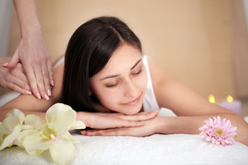Fototapeta na wymiar people, beauty, spa, healthy lifestyle and relaxation concept - close up of beautiful young woman lying with closed eyes in spa