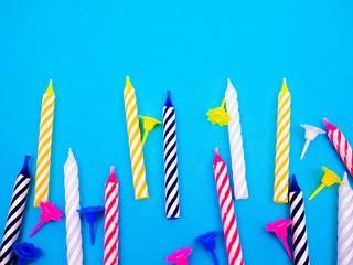 striped colorful candles for birthday party on white background. flat lay.