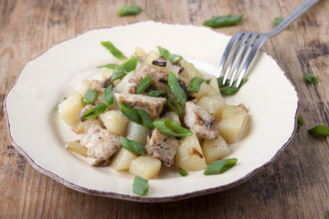 Fried potatoes with chicken and mushrooms