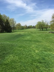 Beautiful view looking down the fairway of a public golf course on a clear warm summer day. Perfect...
