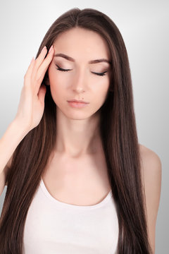 Health And Pain. Stressed Exhausted Young Woman Having Strong Tension Headache. Closeup Portrait Of Beautiful Sick Girl Suffering From Head Migraine, Feeling Pressure And Stress. High Resolution Image