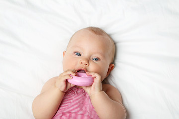 Little newborn baby on white bed