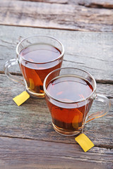 Cup of tea with teabag on wooden table