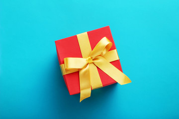 Gift box with ribbon on blue background