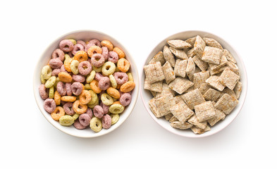 Breakfast cereal squares and ring in bowl.