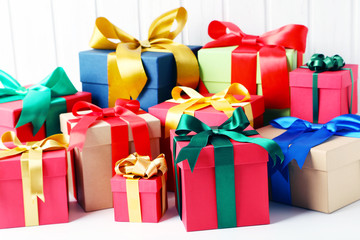 Gift boxes with ribbon on white wooden table