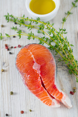 freshly cut raw salmon with spices on wooden surface