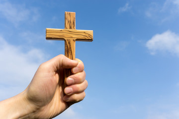 holding wooden cross
