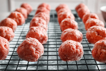 Grid with raw meatballs, closeup