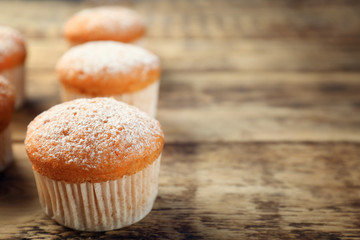 Delicious carrot muffins on wooden background