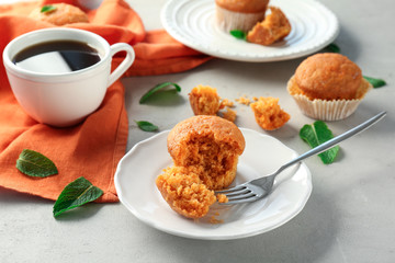 Plate with delicious carrot muffin on table