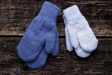 Blue mittens on wood background