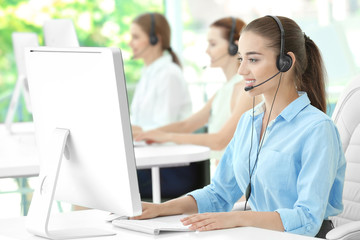 Young female technical support dispatcher working in office