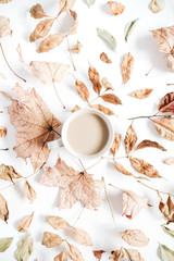 Obraz na płótnie Canvas Coffee with milk and dry autumn leaves. Fall flat lay.