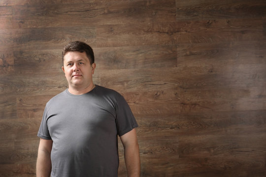 Overweight man on wooden background