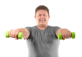 Overweight man with dumbbells on white background