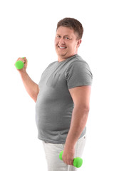 Overweight man training with dumbbells on white background