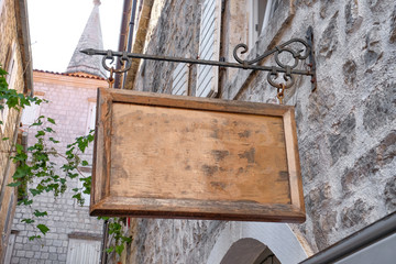 Signboard hanging on building outdoors