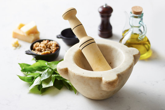 Fresh pesto ingredients with mortar and pestle