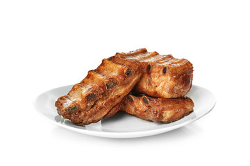 Plate with delicious grilled ribs isolated on white
