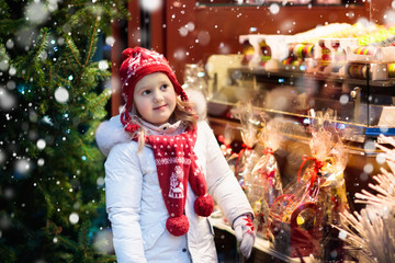 Child at Christmas fair. Xmas market.