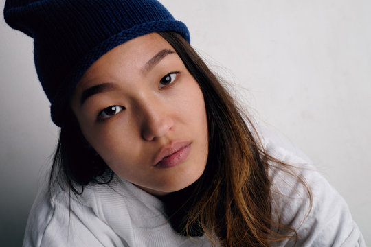 Calm Asian woman in blue hat