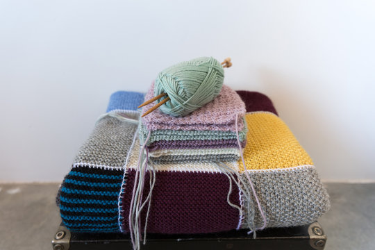 Knitting project with ball of wool and knitting needles