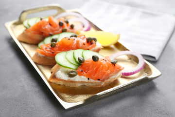 Delicious salmon bruschettas on metal tray