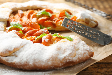 Delicious apricot cake on table, close up