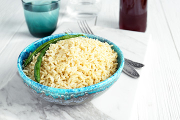 Bowl with brown rice on board