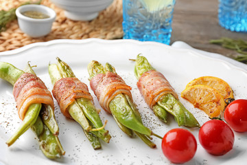 Plate with delicious bacon-wrapped green beans, closeup