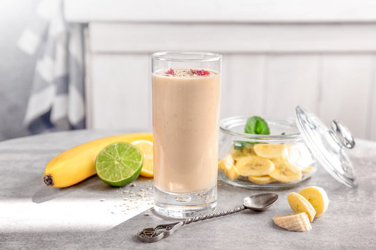 Glass with delicious banana smoothie on table