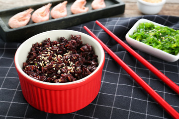 Ramekin with red rice on table