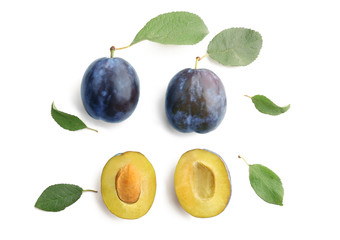 Composition with ripe plums on white background