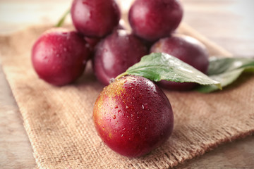 Fresh ripe plums on sackcloth