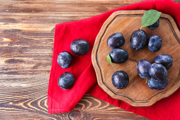 Fresh ripe plums on table