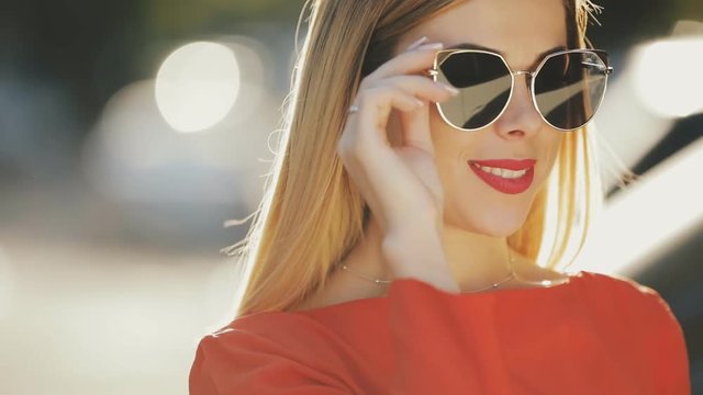Young beautiful woman wearing sunglasses closeup