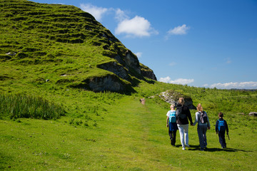 Beautiful green fields and hills of Ireland, hiking family with children