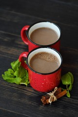 Delicious cocoa wih mint on wooden table 