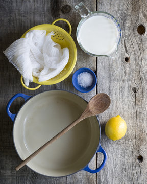 Ingredients on wooden table to make homemade ricotta cheese