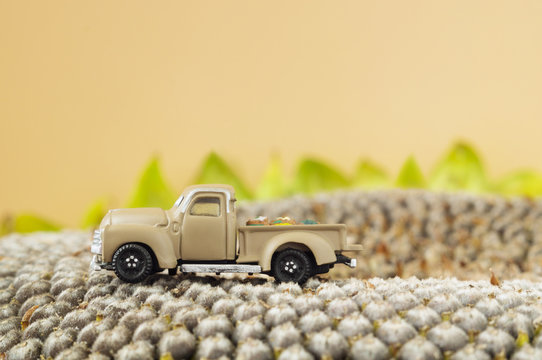 A Little Toy Farm Pickup Truck On Sunflower Seeds.