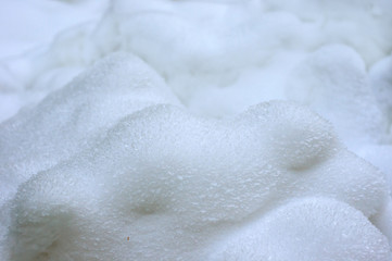 Winter landscape with deep snowdrifts in the frosty morning. White fresh snow lying in deep snowdrifts after the last snowfall. Fresh blue snow close-up in winter season.