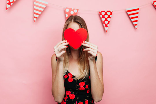 woman with a heart in front of her face